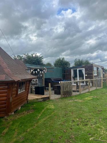 a yard with a house and a house with a fence at Bridie Rose - hot tub extra charge in Kington