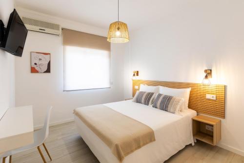 Ένα ή περισσότερα κρεβάτια σε δωμάτιο στο Faro Guest Apartments