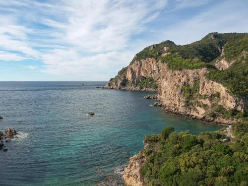 a view of the ocean from a cliff at Hotel Apollon Corfu in Paleokastritsa