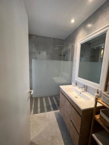 a bathroom with a sink and a shower and a mirror at The Best prime location lovely 1 bedroom apartment in Paphos City