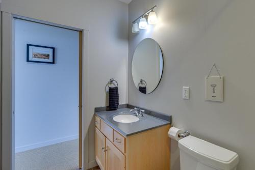 a bathroom with a sink and a mirror and a toilet at Tofte Tranquility Lakefront Townhome with Balcony! in Tofte