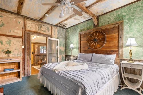 a bedroom with a large bed in a room with green walls at #5 The Dog Run Suite in New Braunfels