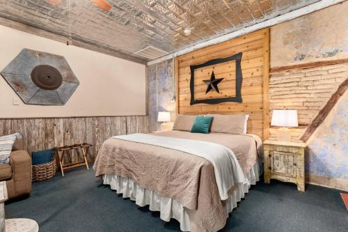 a bedroom with a bed and a wooden wall at #7 The Hideaway in New Braunfels