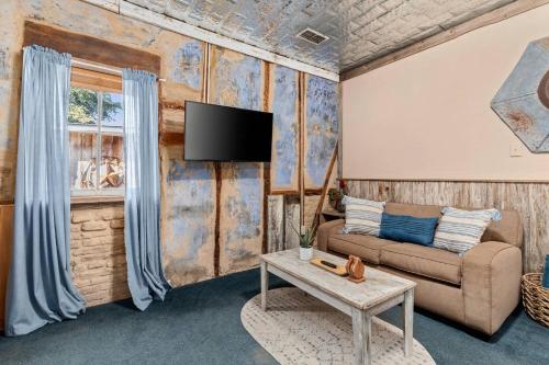 a living room with a couch and a tv at #7 The Hideaway in New Braunfels