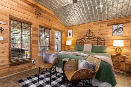 a bedroom with a bed and a table and chairs at #8 The Cabin in New Braunfels