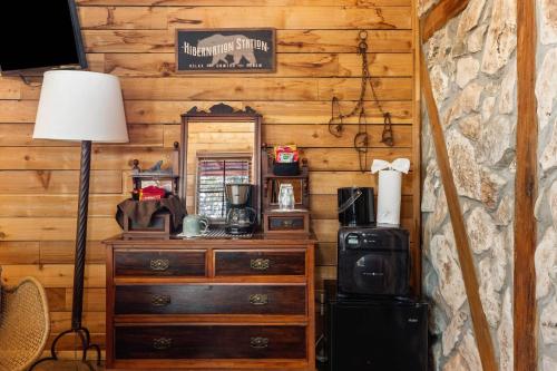a room with a dresser and a mirror in a cabin at #8 The Cabin in New Braunfels
