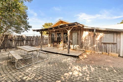 a house with a wooden porch with a patio at #8 The Cabin in New Braunfels