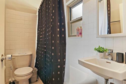 y baño con aseo y lavamanos. en Lively & Fully Furnished 1BR Apartment - Kenwood 408, en Chicago