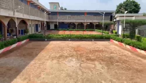 an empty courtyard of a school with a building at CISFOP in Abomey-Calavi