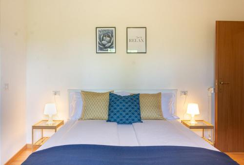 a bedroom with a large bed with two lamps at Casa Varice in Tremosine Sul Garda