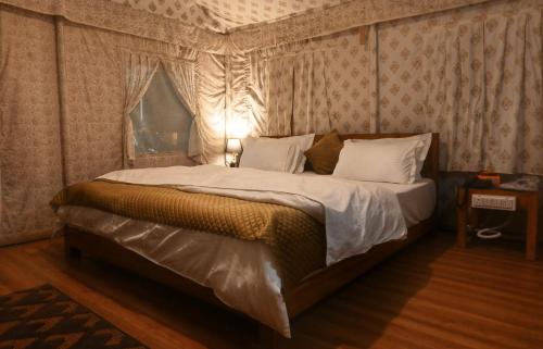 a bedroom with a large bed with a canopy at Bundeli Resorts in Rājgarh