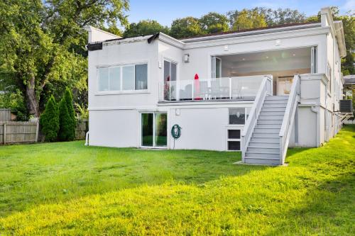 a white house with a lawn in front of it at Piermont Waterfront Villa with Hot Tub in Piermont