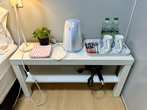 a white table in a bedroom with a coffee maker on it at H&T PJ Gasing - Cabin Studio - Netflix & Free Parking in Petaling Jaya