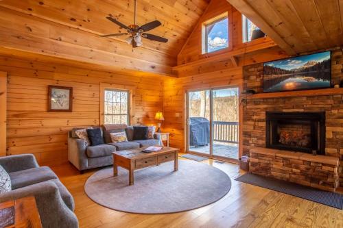 a living room with a fireplace and a tv at Little Elk Lodge in Elk Park