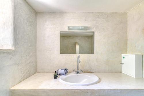 a bathroom with a sink and a mirror at Great house w/ BBQ in Paros in Santa Maria