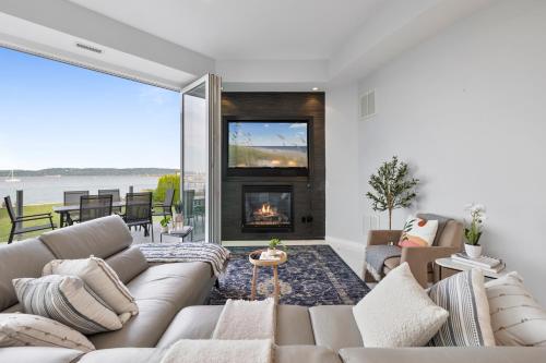 a living room with a couch and a fireplace at Piermont Waterfront Villa with Hot Tub in Piermont
