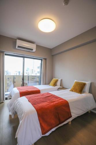 a hotel room with two beds and a window at One-asakusa -TT0207 in Tokyo