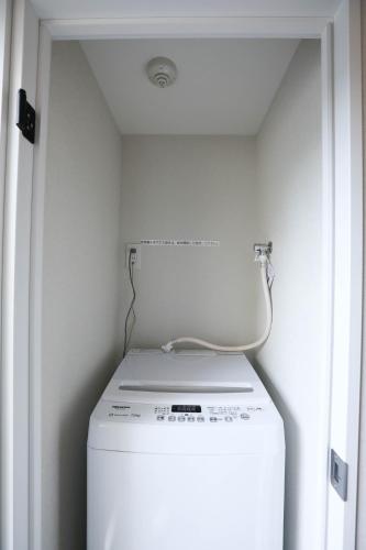 a washer and dryer in a small laundry room at One-asakusa -TT0207 in Tokyo