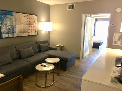a living room with a couch and a table at DoubleTree Suites by Hilton Melbourne Beach Oceanfront in Melbourne