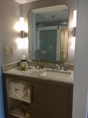 a bathroom with a sink and a mirror at DoubleTree Suites by Hilton Melbourne Beach Oceanfront in Melbourne