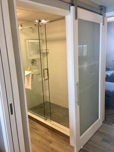 a glass shower door in a bathroom at DoubleTree Suites by Hilton Melbourne Beach Oceanfront in Melbourne