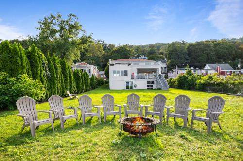a group of chairs and a fire pit in a yard at Piermont Waterfront Villa with Hot Tub in Piermont