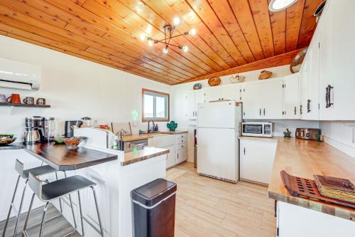 a kitchen with white appliances and a wooden ceiling at Twentynine Palms Desert Oasis with Pool and Hot Tub! in Twentynine Palms