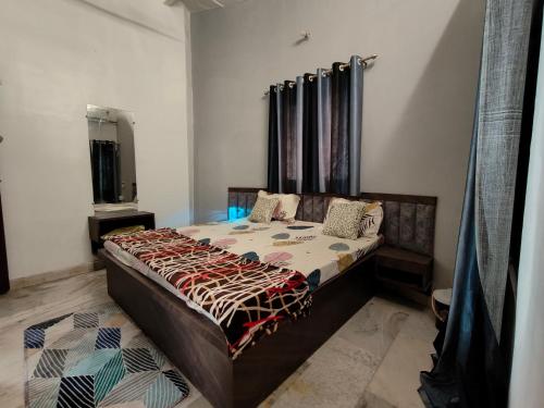 a bedroom with a bed in a room at Naari home stay in Mathura