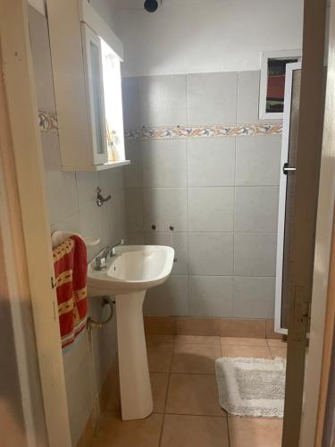 a small bathroom with a sink and a mirror at Fabiana in Gualeguaychú