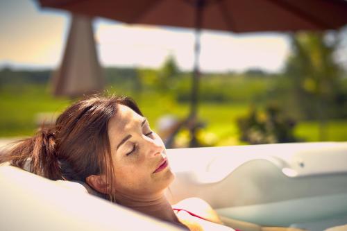 a woman laying on a couch with an umbrella at Auberge West Brome in West Brome
