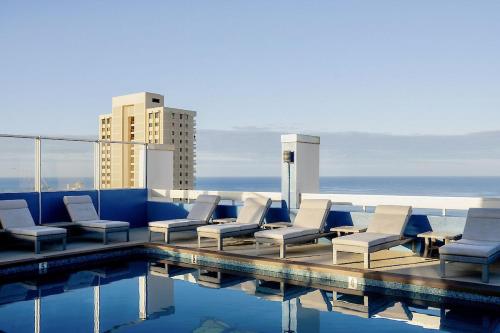 a group of chairs and a swimming pool on a building at Pacific Monarch in Honolulu