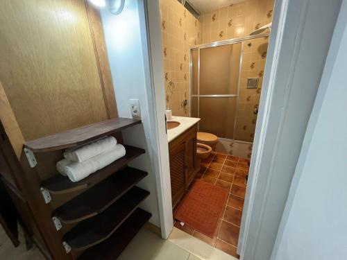 a bathroom with a sink and a toilet and a shower at Adorável apartamento em Ipanema -Best location in Rio de Janeiro