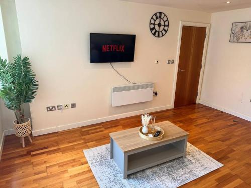 a living room with a tv on a wall at Central 2 Bedroom Apartment - Fast WIFI - Near Broad Street in Birmingham