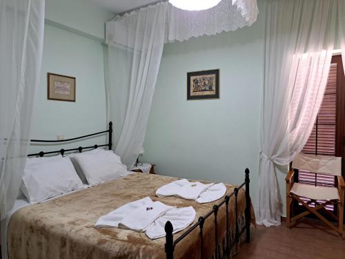 a bedroom with a bed with towels on it at PETRINO in Keratokampos