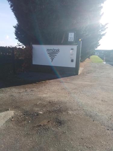 a sign on the side of a road with a rainbow at Penzion U vinaře in Velké Bílovice