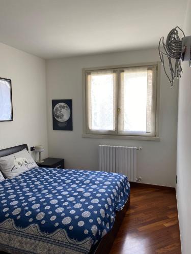 a bedroom with a bed and two windows at la Casa di Luca in Sarnico