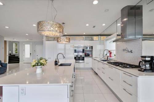 a white kitchen with a large white counter top at Piermont Waterfront Villa with Hot Tub in Piermont