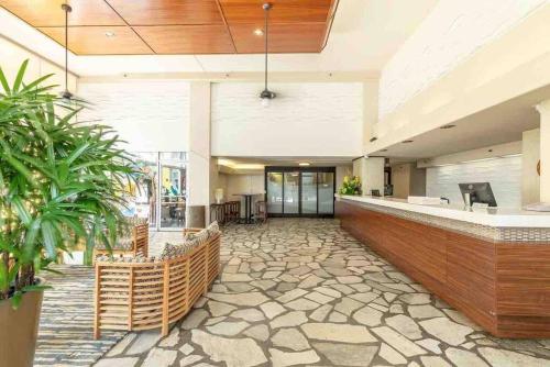 a lobby with a bar in a building at Pacific Monarch in Honolulu
