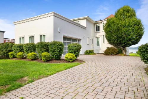 a white house with a brick driveway at Piermont Waterfront Villa with Hot Tub in Piermont