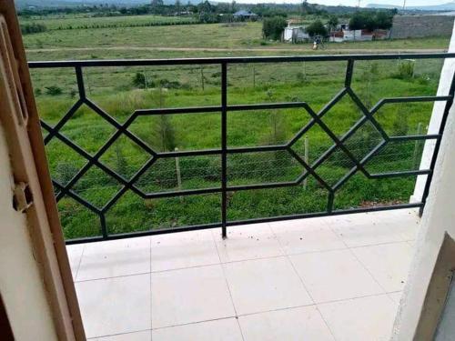 een balkon met uitzicht op een grasveld bij Sagada Resort Lamuria in Nyeri