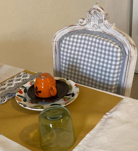 an orange hat on a plate on a table at Antica Novi B & B in Novi Ligure