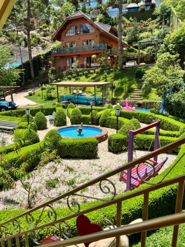 a view of a garden from the balcony of a house at Vila husky pousada in Campos do Jordão
