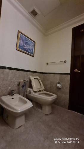 a bathroom with a toilet and a bidet at Glorious Service Suite At Times Square in Kuala Lumpur