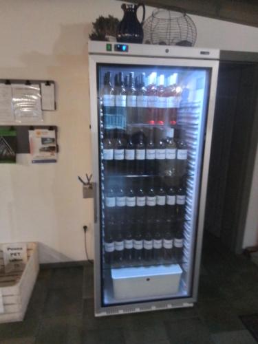 a refrigerator filled with lots of bottles of beer at Penzion U vinaře in Velké Bílovice