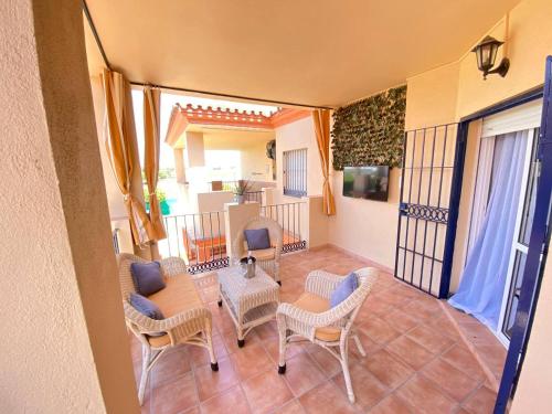 a room with a table and chairs and a balcony at Apartamento Camaleón in Chipiona