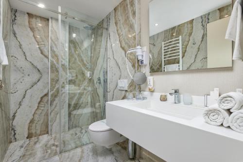 a bathroom with a sink and a shower at Hotel Splendido Bay in Tivat