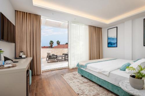 a bedroom with a bed and a view of a patio at Hotel Splendido Bay in Tivat