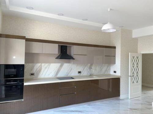 a kitchen with a sink and a stove at Spacious 3 bedroom with sea view in Baku