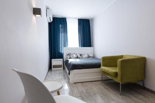 1 dormitorio pequeño con 1 cama y 1 silla en Квартири метро Дарниця світло завжди є en Kiev