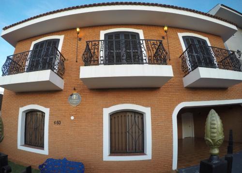 a red brick building with two balconies on it at Black Hotel in Bauru